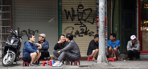 Local drinks green tea while chatting along the sidewalks
